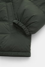 Close-up side view of the Canada Goose Down jacket 'Sterling' dark green, showcasing high-quality microfiber, smooth touch, water-repellent fabric, warm down filling, oversized fit, high-closing two-way zipper, wind flap with snap buttons, quilted hood wi