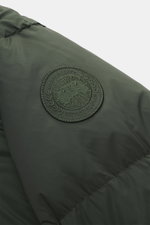 Close-up view of the Canada Goose Down jacket 'Sterling' dark green, showcasing the typical woven label on the upper arm, made of high-quality microfiber with a smooth touch, water-repellent fabric, warm down filling, oversized fit, high-closing two-way z