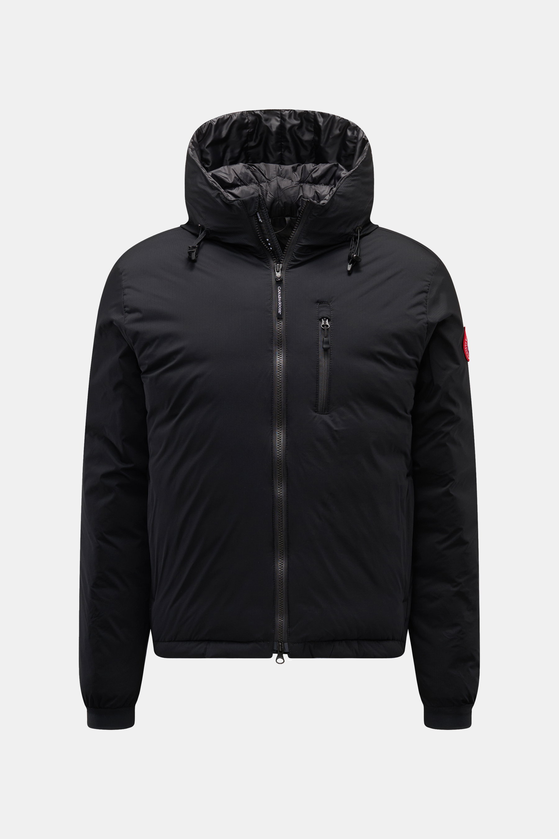 Front view of Canada Goose Down jacket 'Lodge Hoody' black with padded hood, ripstop microfiber fabric, slim fit, two-way zip, breast and side pockets, elastic cuffs, and Canada Goose logo on sleeve. Maximum comfort in a lightweight design with lightweigh