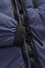 Close-up front view of the Canada Goose Down Jacket 'Lodge Hoody' Dark Blue showing zipper, elastic cuff, and ripstop microfiber fabric. Maximum comfort in a lightweight design: The packable down jacket 'Lodge Hoody' by CANADA GOOSE features a padded hood