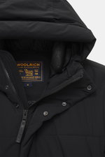 Close-up front view of Woolrich Down jacket 'Matt' black, showing high-quality microfiber, wind- and water-repellent fabric, slim fit, warm down filling, durable two-way zipper, wind flap with snap buttons, high-closing collar with hood, hand warming pock