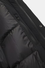 Close-up view of the inside of the Woolrich Down jacket 'Matt' black, showing high-quality microfiber, quilted lining fabric, two inner pockets with durable two-way zipper and snap button wind flap. The jacket features warm down filling, wind- and water-r