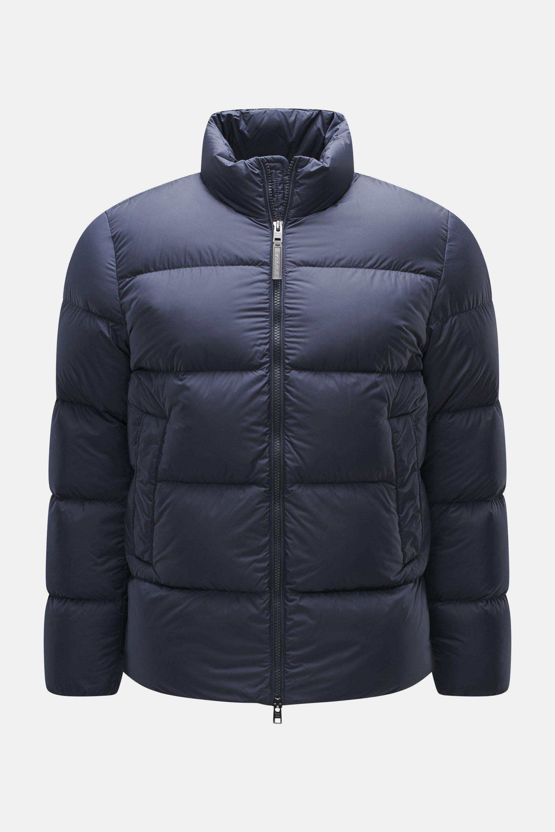 Woolrich Down jacket dark blue shown front view, slim fit with high-quality microfiber, smooth feel, warm down filling, durable two-way zipper, piped front pockets, adjustable hem, quilted lining fabric, and two inner pockets.