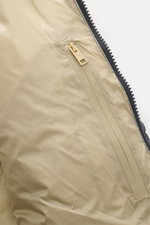 Close-up inside view of Woolrich Down jacket dark blue showcasing high-quality microfiber with smooth feel, warm down filling, slim fit, durable two-way zipper, piped front pockets, adjustable hem, quilted lining fabric, and two inner pockets.