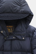 Close-up front view of Woolrich Down jacket 'Cloud Davis' dark blue, showcasing high-quality microfiber, smooth touch, warm down filling, slim fit, robust two-way zipper, welted hand warming pockets, front pockets with flap, practical hood, quilted lining