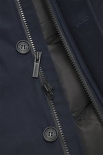 Close-up front view of Woolrich Down jacket 'Heavy GTX' navy showing high-quality microfiber fabric, robust two-way zipper, wind flap with buttons, and button with Woolrich logo. The jacket features wind- and water-repellent material, warm down filling, s