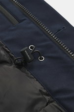 Close-up front view of Woolrich Down jacket 'Heavy GTX' navy showing high-quality microfiber fabric, robust two-way zipper, wind flap with buttons, adjustable waist width, quilted lining fabric, and branded drawstring with practical windproof cuffs. Featu