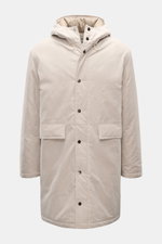 Front view of the 04651/ A trip in a bag Parka 'MC26' sand made from lightly waxed cotton with wool-mix lining, high collar, hood, two-way zipper, snap-button wind flap, large flap pockets, and inner pocket; inspired by the Winter Olympics in Cortina and 