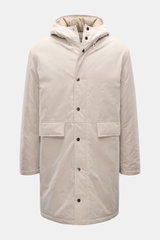 Front view of the 04651/ A trip in a bag Parka 'MC26' sand made from lightly waxed cotton with wool-mix lining, high collar, hood, two-way zipper, snap-button wind flap, large flap pockets, and inner pocket; inspired by the Winter Olympics in Cortina and 