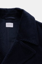 Close-up front view of the 04651/ A trip in a bag Corduroy pea coat navy showing its wide wale corduroy texture, wide lapel collar, and label inside. Make a statement this autumn with the pea coat 'Cord Peacoat' by 04651/ A TRIP IN A BAG: Its classic desi