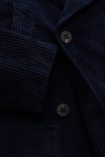 Close-up front view of 04651/ A trip in a bag Corduroy pea coat navy showing wide wale cotton corduroy fabric, double-breasted three-button placket, wide lapel collar, and front pocket flap. Make a statement this autumn with the pea coat 'Cord Peacoat' by