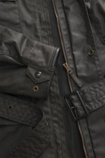 Close-up front view of Belstaff Waxed jacket 'Trialmaster Phoenix' dark brown in waxed cotton with leather details, zipper, waist belt, and snap buttons.