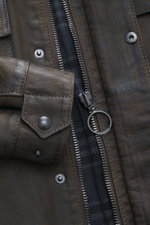 Close-up front view of the Belstaff Leather Jacket 'Gangster' Brown showing nubuck leather, zipper with ring pull, press studs, and checkered lining fabric. For a cool look since 1969: The leather jacket 'Gangster' by the biker label BELSTAFF is an icon t