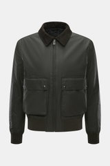 Front view of the Belstaff Wax blouson 'Mount Jacket' dark olive in waxed cotton with corduroy collar, patch pockets, ribbed cuffs, and metal zipper, featuring checked cotton lining and a slim fit, combining military aesthetics with British motorcycle tra