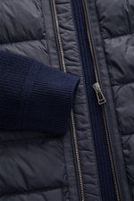 Close-up front view of Belstaff Down knit jacket 'Compound' navy showing soft pure wool patent knit sleeve, quilted microfiber front with light down filling, robust zipper.

Description: <p>Soft patent knit made of pure wool, combined with a pleasantly li