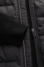 Close-up front view of the Belstaff Down knit jacket 'Compound' black showing soft patent knit pure wool sleeve with ribbed cuff, quilted microfiber front, slim fit, robust zipper, and smooth touch. <p>Soft patent knit made of pure wool, combined with a p