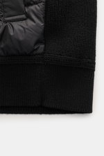 Close-up front view of the Belstaff Down knit jacket 'Compound' black showing soft pure wool patent knit and quilted microfiber with light down filling.

Description: <p>Soft patent knit made of pure wool, combined with a pleasantly light down quilted fro
