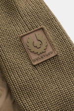 Close-up front view of Belstaff Down knit jacket 'Compound' khaki showing soft patent knit of pure wool with medium-fine pattern and BELSTAFF woven label on sleeve. The jacket features a quilted microfiber front with light down filling, smooth touch, slim