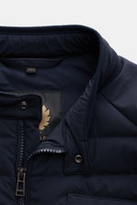 Close-up top view of Belstaff Down jacket 'Chassis' navy collar and zipper, showcasing smooth microfibre, lightweight down, and snap button tab. Indispensable outdoor must-have in casual BELSTAFF style: The lightweight down jacket 'Chassis' offers unlimit