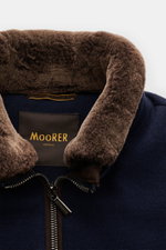 Close-up front view of the Moorer Down blouson 'Bellati' navy showing the slim standing collar with detachable shearling trim, two-way zip, and knit wool-cashmere exterior with lightweight down lining. Features elasticated cuffs and hem, zip front pockets