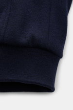 Close-up front view of the navy knitted outside sleeve cuff of the Moorer Down blouson 'Bellati' navy, blend of wool and cashmere, lightweight down lining, slim fit, two-way zip, slim standing collar, detachable shearling trim, zip front pockets, elastica