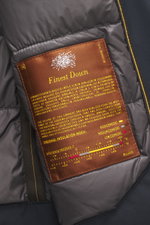 Close-up inside view of the Moorer Down Jacket 'Evan' navy showing a brown label with "Finest Down" text, highlighting its knit from elastic cotton, fine knit pattern, high-quality microfiber body with smooth touch, light down filling, slim fit, detachabl