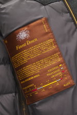Close-up inside view of the Moorer Down Jacket 'Pagni' navy showing the brown label with finest down details, smooth lining fabric, and part of the microfiber interior.
