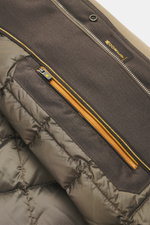 Close-up inside view of Moorer Daunenjacke 'Nobile' dunkelbraun showing elastic microfiber lining, smooth texture, yellow zip, and label, highlighting its water-repellent, slim fit design with double-front zipper and variable collar.