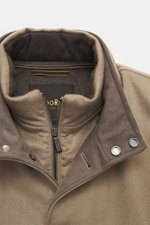 Close-up front view of Moorer Cashmere down blouson 'Janos' beige, showing soft cashmere texture, stand-up collar with snap buttons, six-button placket, zipper, velour leather trim, and ribbed cuffs. The Cashmere Down Blouson 'Janos' by MOORER perfectly c