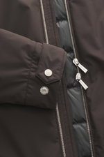 Close-up front view of the Moorer Down jacket 'Albini' anthracite, showing high-quality microfiber fabric, two-way zipper, snap button cuff, and quilted lining fabric. With a short cut, the luxurious, water-repellent jacket 'Albini' with detachable hood b