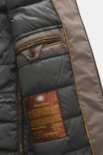 Close-up interior view of the Moorer Down jacket 'Albini' anthracite showing quilted lining, buttoned inside pocket, and label; luxurious, water-repellent, slim fit with warming down filling, detachable hood, two-way zipper, adjustable cuffs and hem, high
