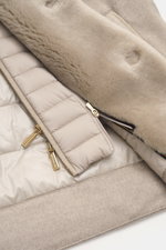 Close-up photo from above of the beige Moorer Cashmere down jacket 'Teodor' showing soft cashmere, warm down filling, quilted lining, and gold zippers. Style meets function: The down jacket from MOORER combines modern elegance with functional warmth perfo