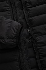 Close-up frontal view of the Stone Island Down Jacket 'Seamless Tunnel Nylon Down-TC' black showcasing its high-quality microfiber, smooth touch, lightweight down filling, two-way zipper, elastic sleeve cuffs, and detailed stitching.

Description: <p>The 