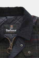 Close-up view from above of the Barbour Wool Jacket 'Tartan Bedale' navy/dark green/burgundy checkered showing the fine corduroy collar, quilted lining, two-way zipper, and logo embroidery on the left pocket flap, made of pure wool with a tartan woven pat