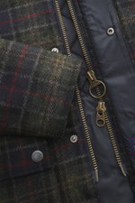Close-up front view of Barbour Wool Jacket 'Tartan Bedale' navy/dark green/burgundy checkered, showing wool tartan pattern, corduroy collar trim, brass zipper, snap buttons, and quilted lining. Well prepared for the transitional season: This version of th