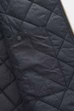 Close-up image of the quilted lining and snap button of the Barbour Wool Jacket 'Tartan Bedale' navy/dark green/burgundy checkered, photographed from above. Well prepared for the transitional season: This version of the 'Bedale' jacket by BARBOUR is made 