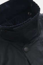 Close-up, top-down view of Barbour Wax jacket 'Beaufort' dark navy showing the corduroy collar, snap buttons, and waxed cotton fabric.

Description:  
<p>True classic from BARBOUR: The long-cut wax jacket 'Beaufort' made of water-repellent, waxed cotton w
