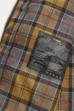 Close-up inside view of Barbour Wax jacket 'Beaufort' dark navy showing characteristic tartan lining and care label.

Description for image content: True classic from BARBOUR: The long-cut wax jacket 'Beaufort' made of water-repellent, waxed cotton with c