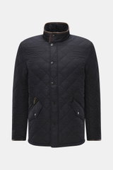 Front view of Barbour Quilted jacket 'Powell Quilt' navy in slim fit, featuring high-quality microfiber, light padding, fleece lining, two-way zipper, wind flap with snap buttons, stand-up collar with corduroy trim, front flap pockets, welt zipper pocket,
