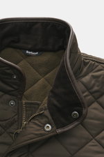 Barbour Quilted jacket 'Powell Quilt' dark olive close-up front top view showing quilted microfiber, corduroy collar, fleece lining, zipper, and snap buttons.