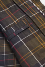 Close-up front view of the Barbour Wax jacket 'Beaufort Icons' purple showing its characteristic tartan lining fabric and zipper.