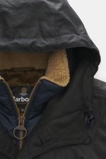 Close-up front view of the Barbour Wax parka 'Ursula' dark navy hood showing waxed cotton typical material texture, water-repellent, breathable, double front with robust two-way zipper, smooth button placket, hood with drawstring, quilted lining, and beig