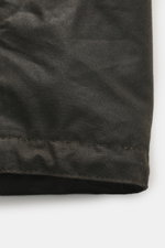 Close-up front view of Barbour Wax parka 'Bedale' dark olive showing hard-wearing wax cotton material with visible stitching.

Description: An icon among wax jackets, the BARBOUR 'Bedale' returns this season as a parka, with extra length and even more pro