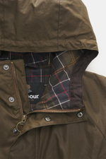 Close-up front view of the Barbour Wax parka 'Bedale' brown showing waxed cotton hood, tartan lining, zipper, and snap buttons.