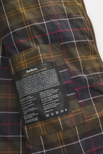 Close-up inside view of the Barbour Wax parka 'Bedale' brown showing signature tartan lining and classic wax care guide label.

Description: An icon among wax jackets, the BARBOUR 'Bedale' returns this season as a parka, with extra length and even more pr