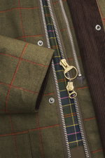 Close-up front view of Barbour Paul Smith Loves Barbour Beaufort Wool Jacket showing pure wool fabric, corduroy collar, two-way zipper, and colorful tartan lining.

<p>Cool collaboration from BARBOUR and PAUL SMITH: The 'Beaufort' wool jacket made of pure