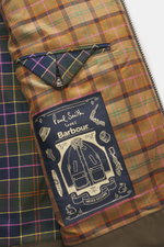 Close-up inside view of Barbour Paul Smith Loves Barbour Beaufort Wool Jacket showing colorful tartan lining, buttoned pocket flap, and label.

Description: 
<p>Cool collaboration from BARBOUR and PAUL SMITH: The 'Beaufort' wool jacket made of pure wool w