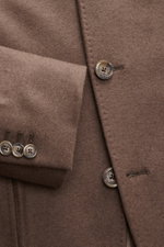 Close-up front and sleeve view of the Fedeli Cashmere Jersey Jacket 'Damon' brown, showcasing soft pure cashmere jersey, slim fit, four-button style with kissing buttons, variably wearable collar, classic breast pocket, patch hip pockets, rear side vents,