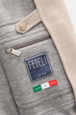 Nahaufnahme des Fedeli Cashmere-Blouson 'Surreale' beige von innen, zeigt Reißverschluss, Knopf, Strickdetails und Innenfutter aus reiner Cashmere-Qualität.
