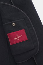 Close-up interior view of the Montecore Cashmere Jacket navy showing the soft pure cashmere fabric, branded button, and red label.